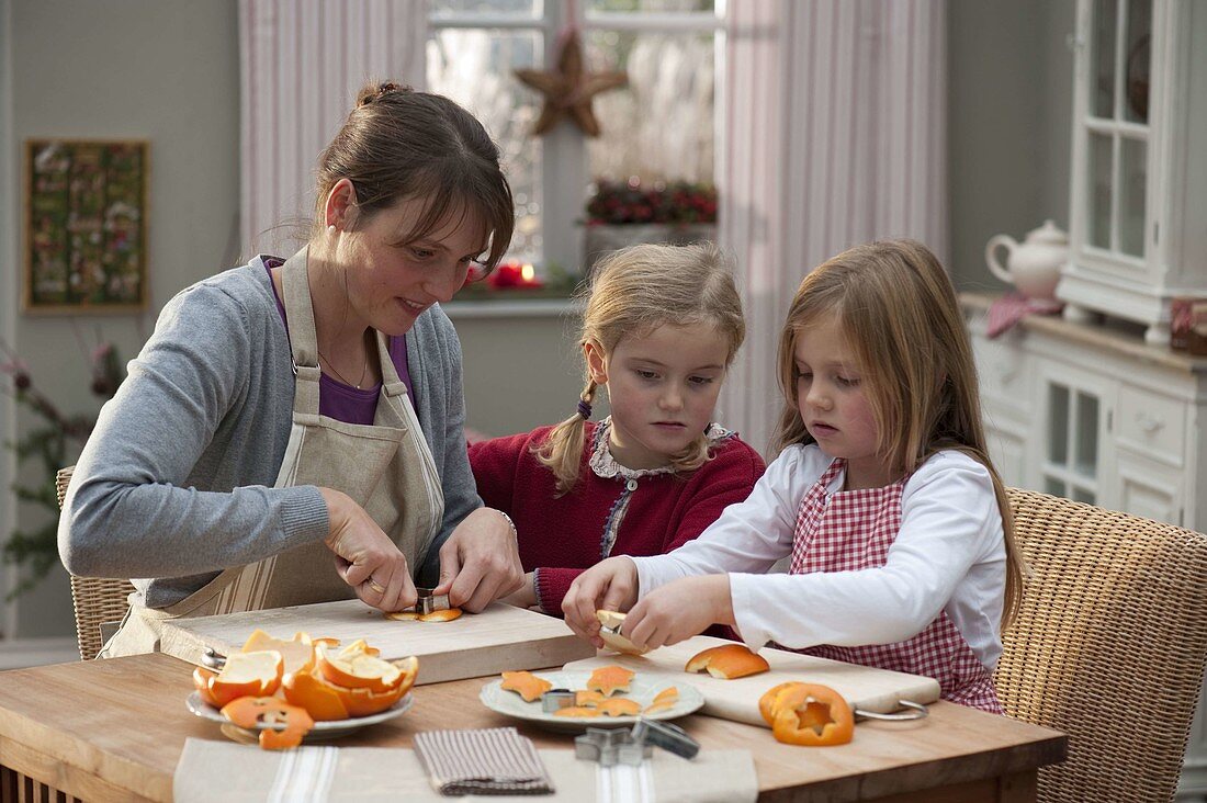 Cutting out orange peel as tree decoration