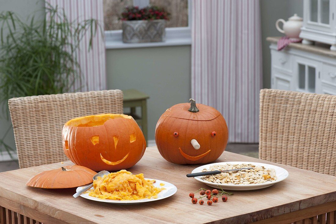 Mother and daughters making pumpkin heads