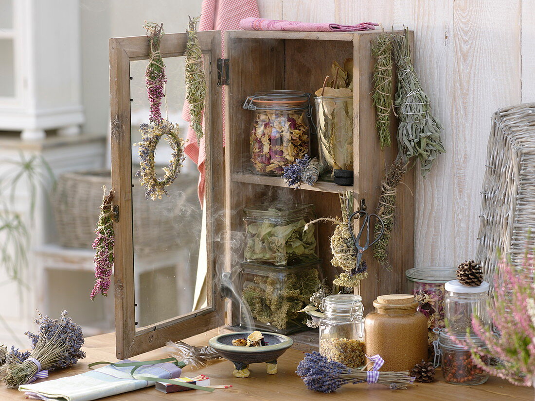 Small cupboard with dried herbs and incense bundles