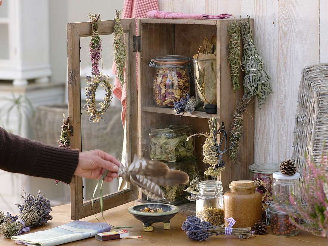 Small cupboard with dried herbs and smoking bundles