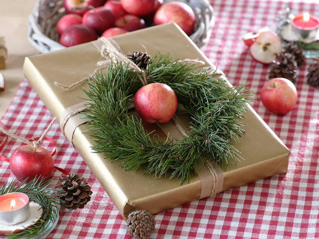 Natural gift box decorated with wreath of Pinus