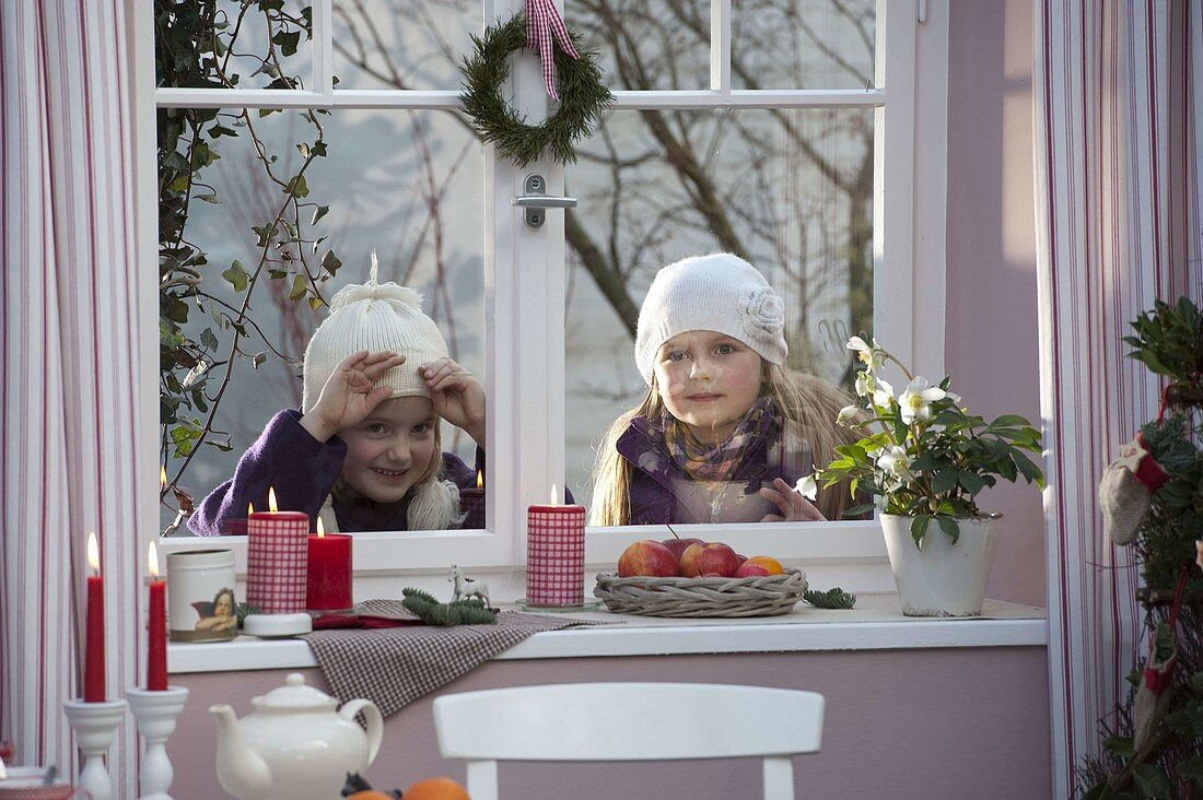 Girls looking into the room from outside