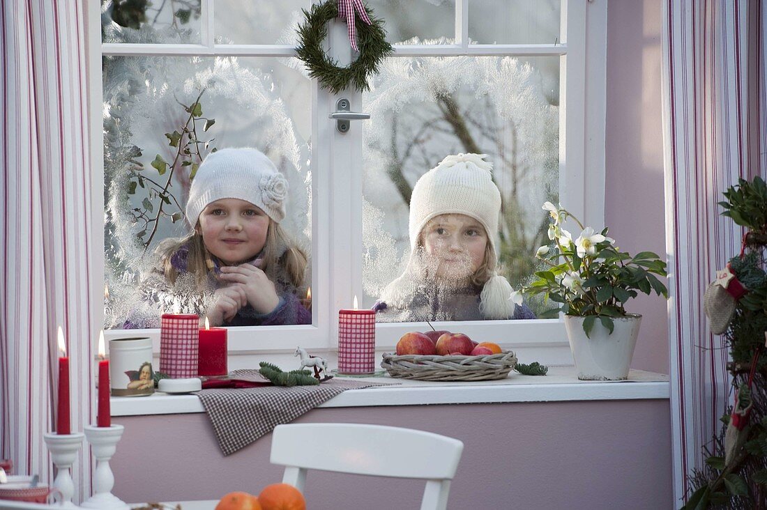 Girls looking into the room from outside