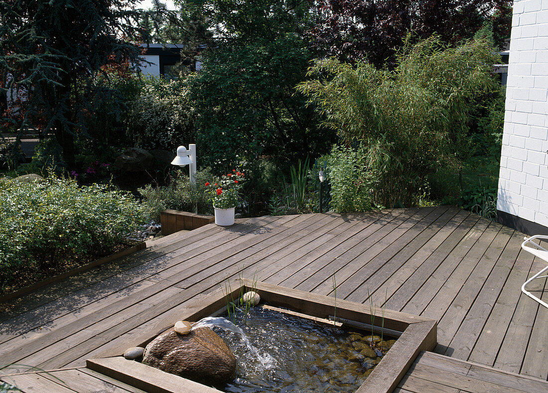 Wooden terrace with integrated pond