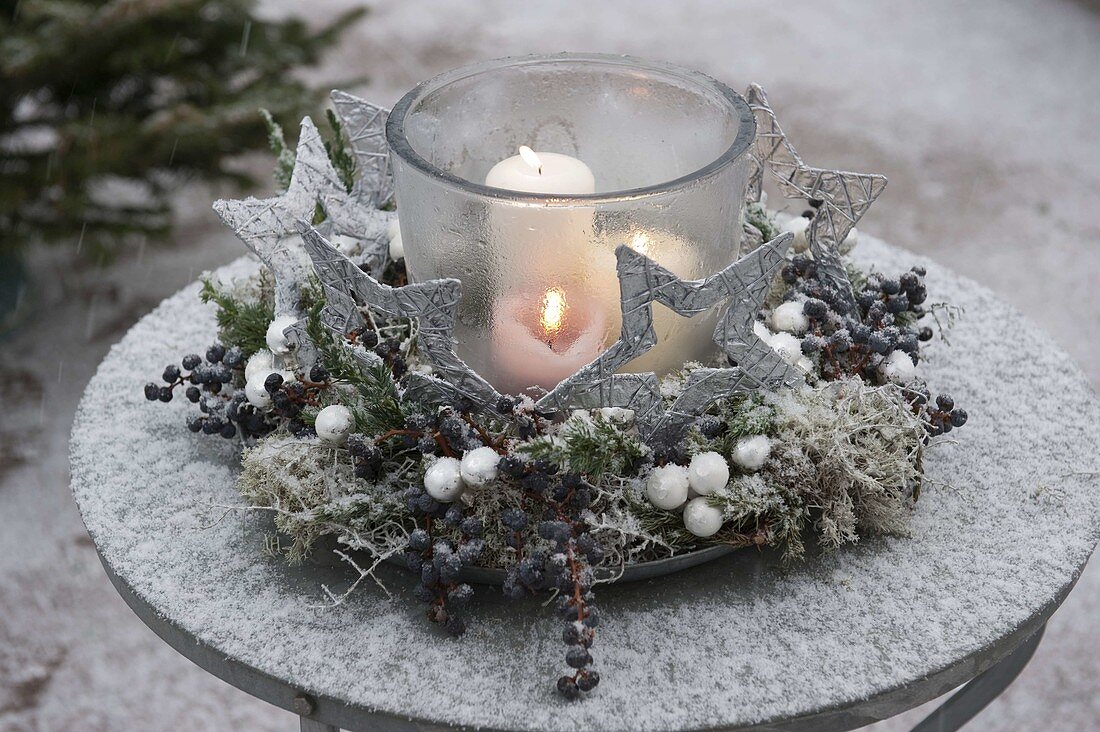 Frozen lantern in wreath of Juniperus (juniper)