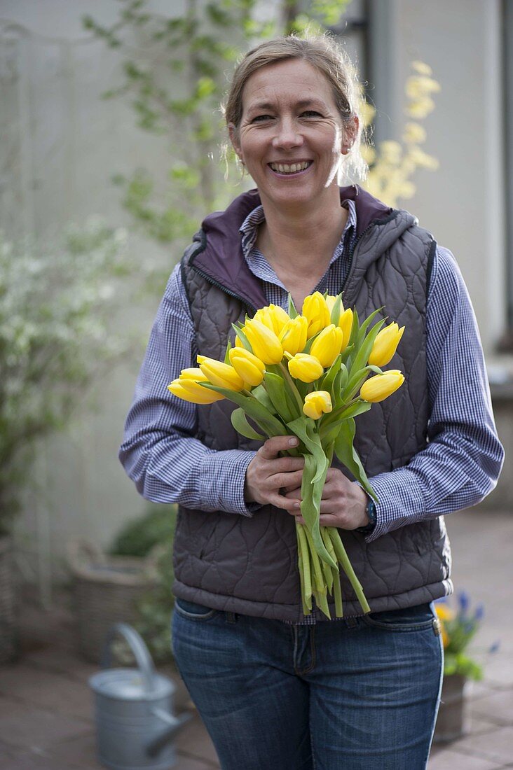 Woman with yellow tulip bouquet