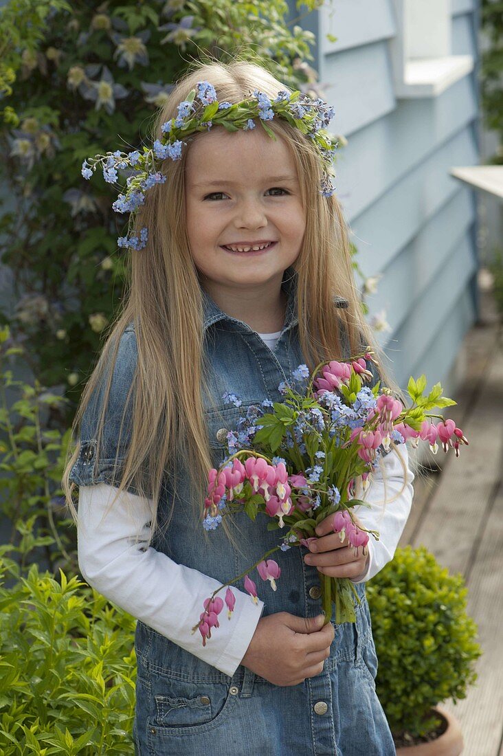 Girl with bouquet of Dicentra (Weeping Heart) and Myosotis