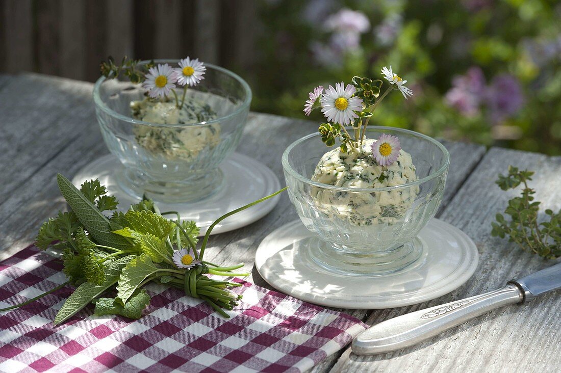 Homemade herb butter decorated with Bellis perennis
