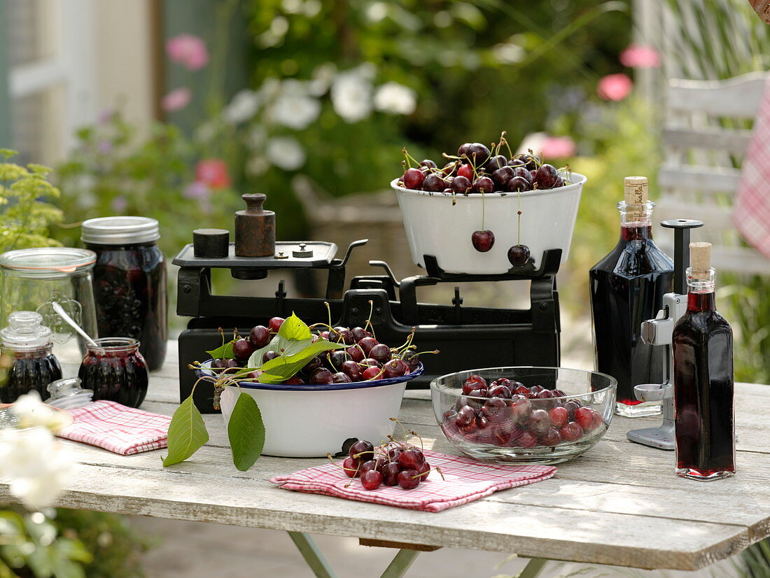 Sweet cherries preserved as juice, compote and jam in jars and bottles