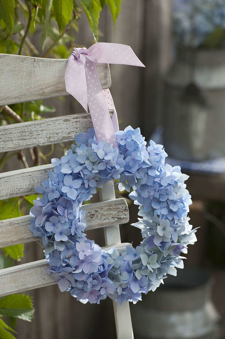 Wreath made of hydrangea hung on chair back