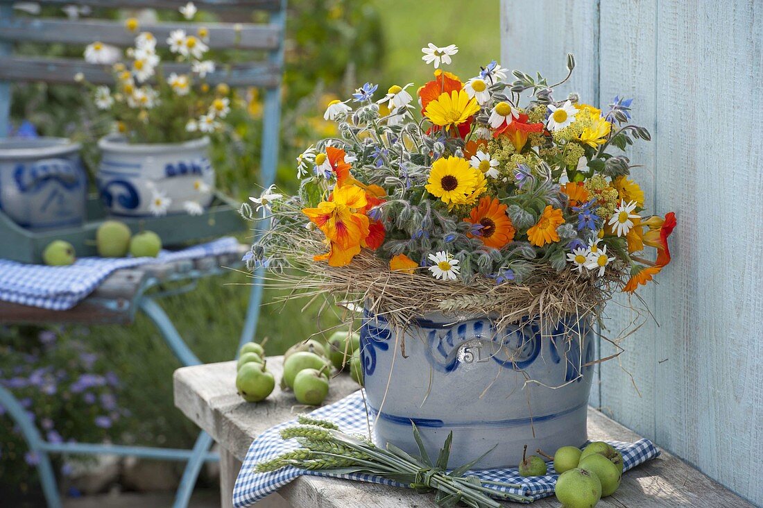 Herb bouquet with marigolds (calendula), borage (Borago)