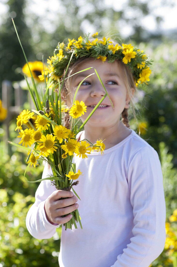 Girl with bouquet and wreath from Anthemis tinctoria