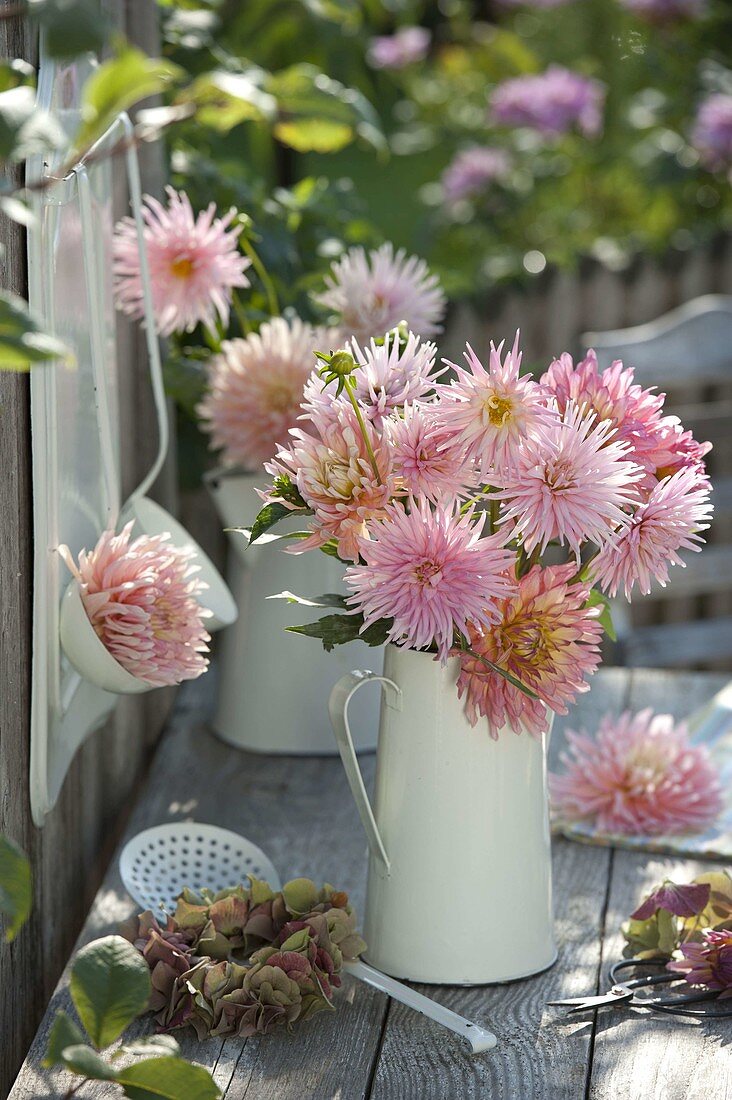 Pink dahlia bouquet in a white jug, wreath of hydrangea