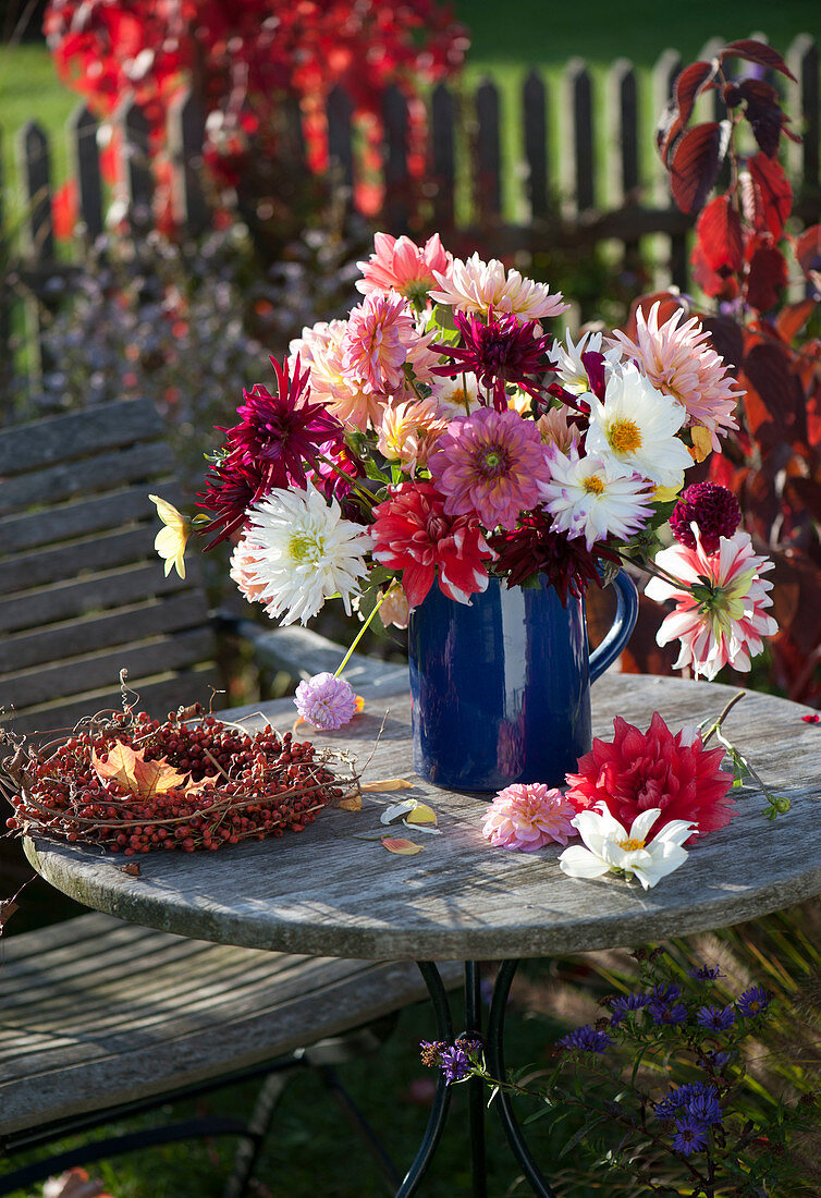 Bouquet of mixed Dahlia (Dahlias) in blue jug and wreath