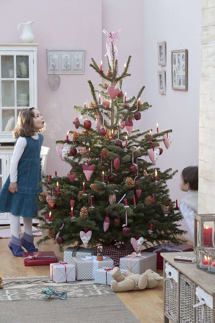 Christmas tree with hearts, cones and apples