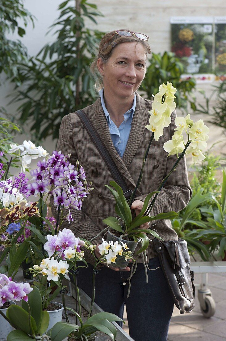 Woman buying flowers at garden centre