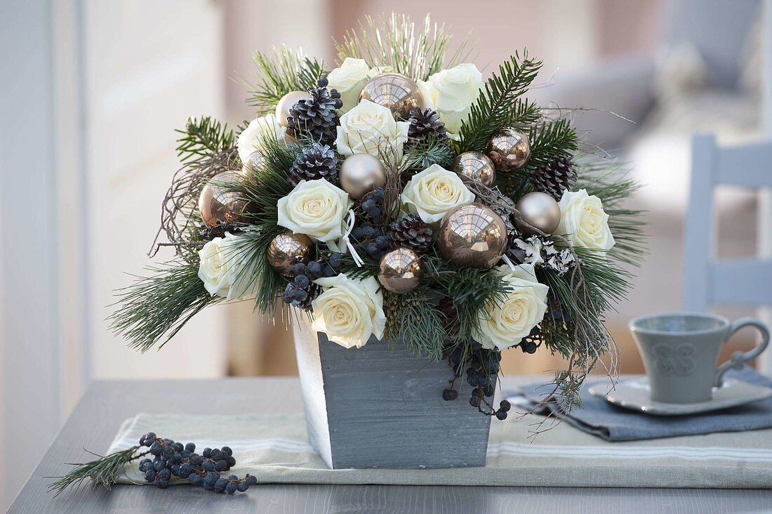 Christmas bouquet with Rosa 'Dolomiti' (white roses), Abies (fir), Pinus