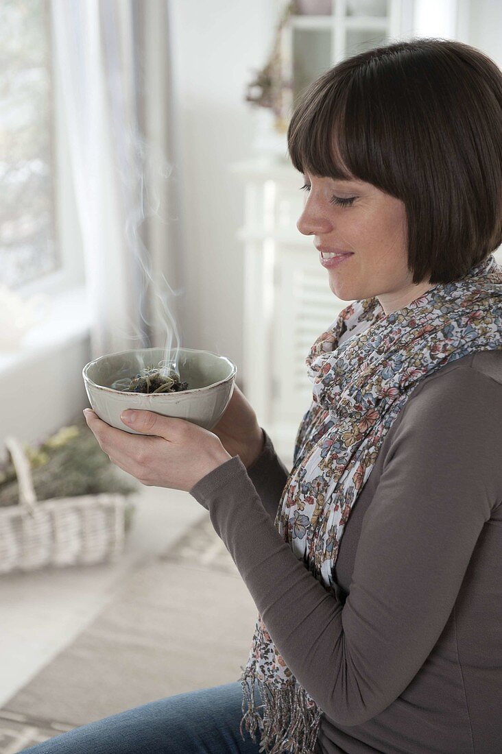 Woman smoking herbs in herb bowl