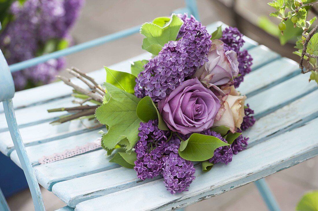 Lying bouquet of pink (rose), syringa (lilac) and leaves