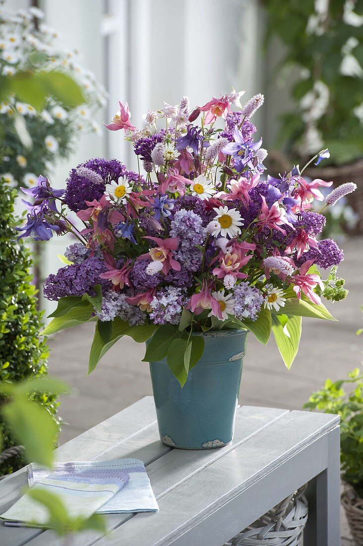 Fragrant spring bouquet with Syringa (lilac), Aquilegia (columbine), Allium