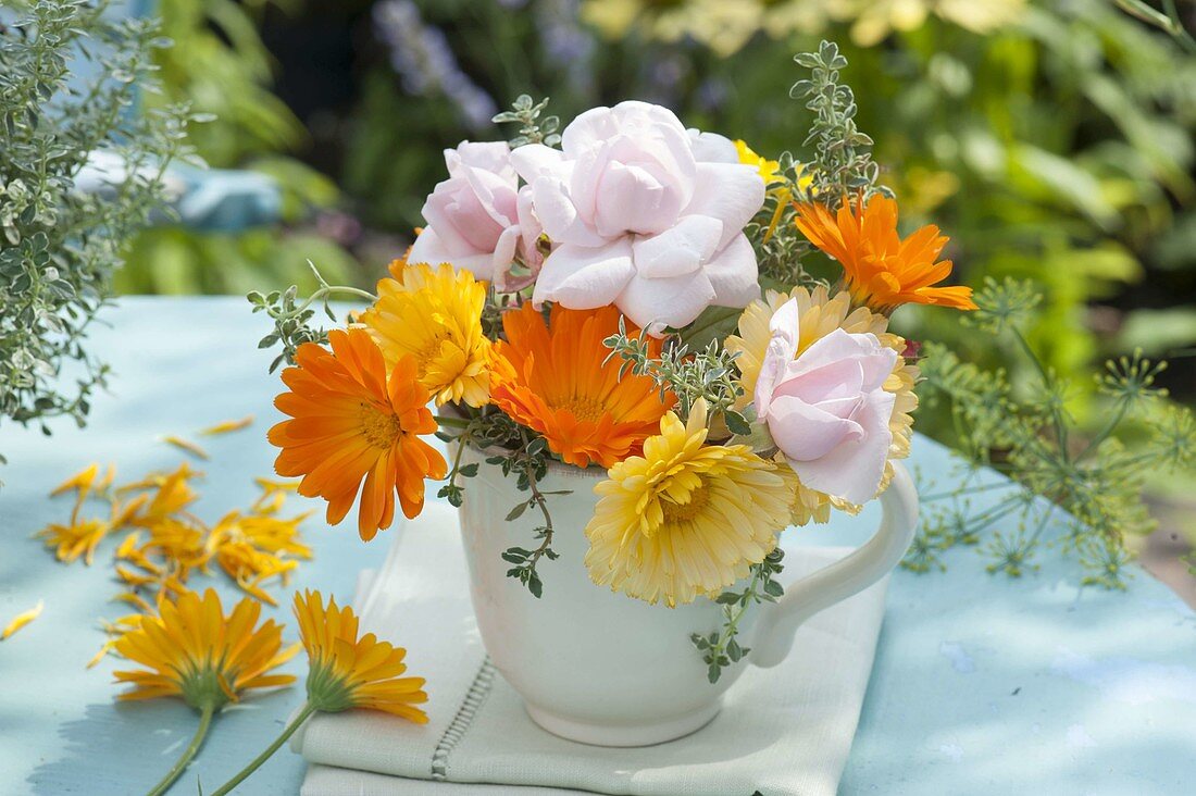 Small bouquet made of calendula (marigold), pink (rose)