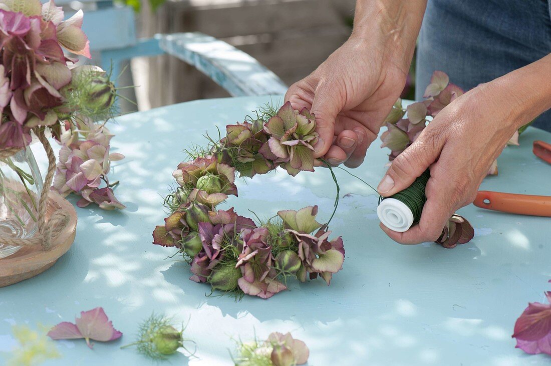 Wreath made of hydrangea flowers and maiden in the countryside