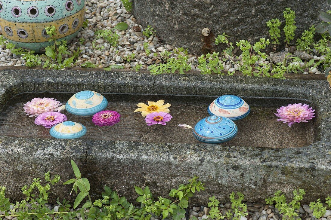 Pottery floating balls floating in a granite trough