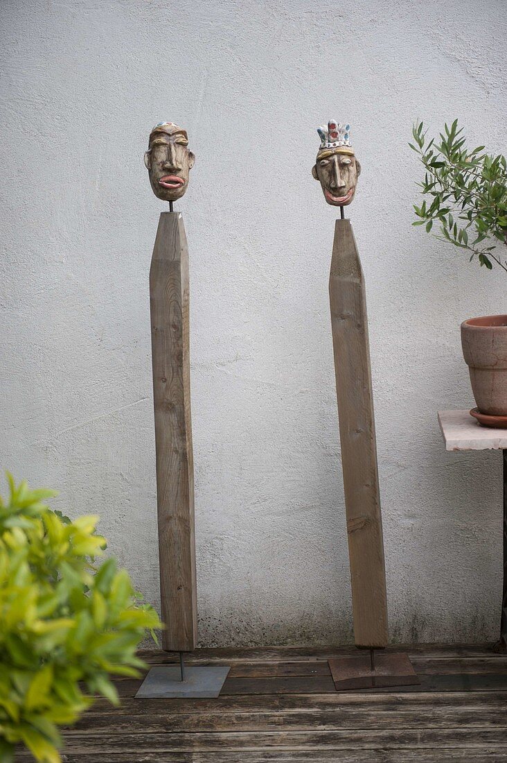 Potted heads on wooden posts