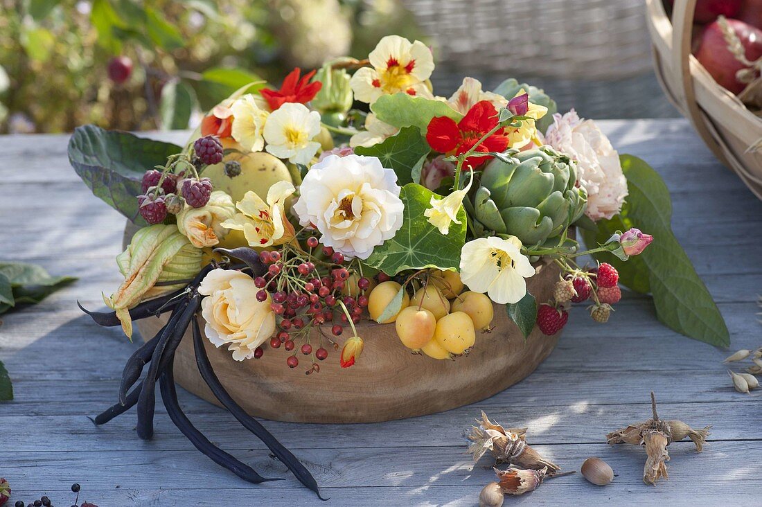 Wooden bowl with pink (roses and rose hips), tropaeolum
