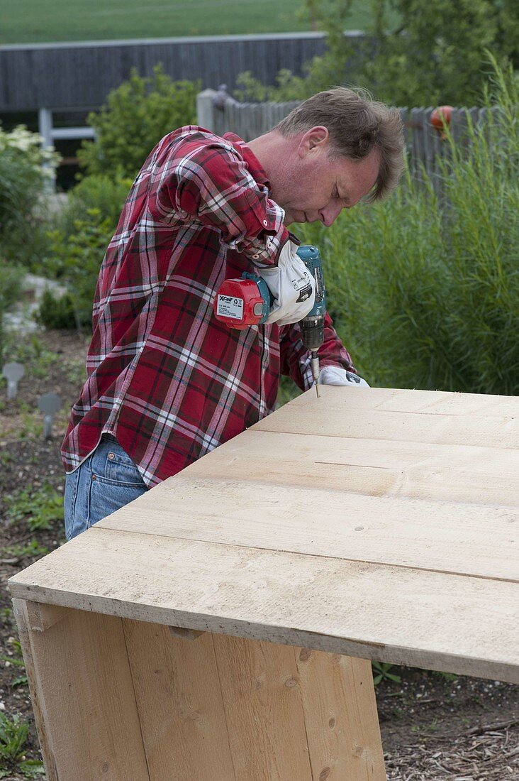 Build a raised flower bed of boards