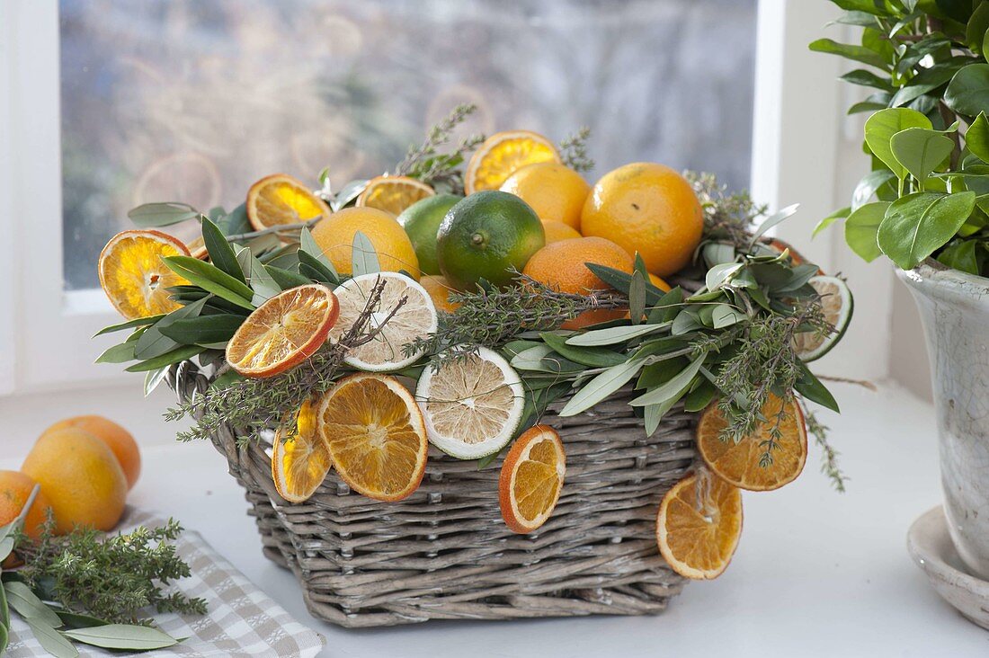 Basket with citrus (oranges and limes), dried orange slices