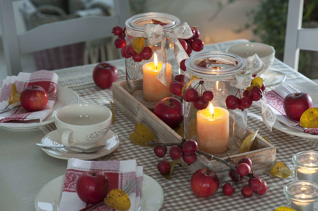 Table decoration with ornamental apples and apples