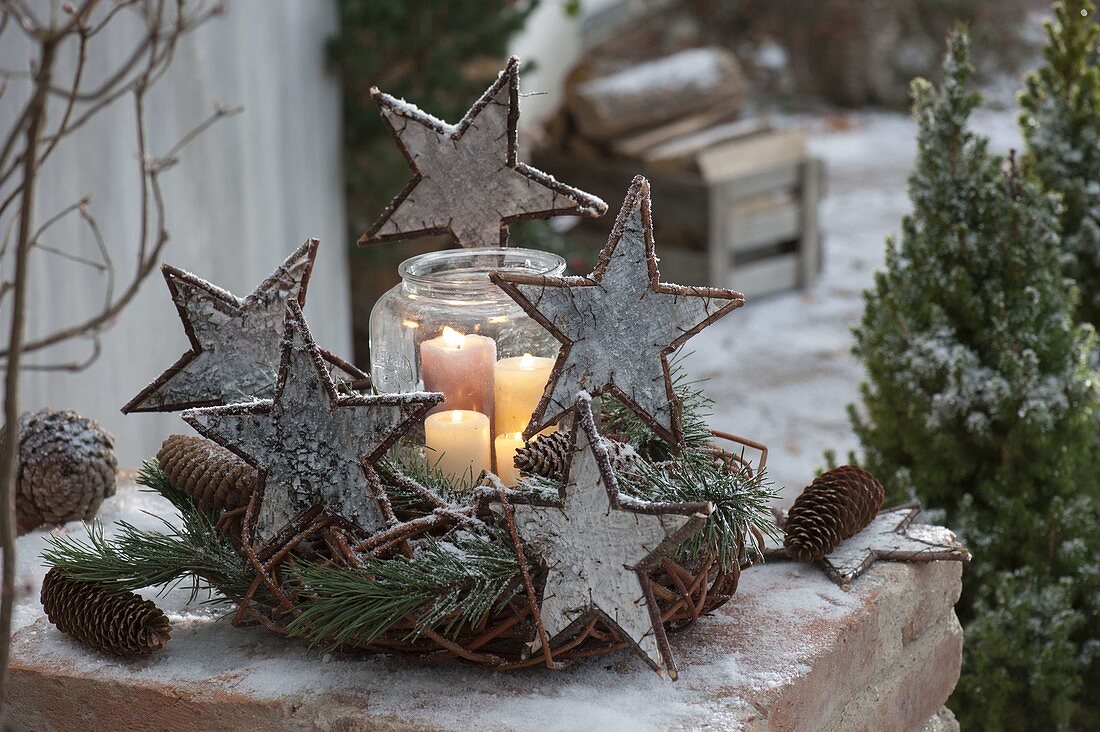 Advent wreath made of wreath blank with branches of Pinus (pine), stars