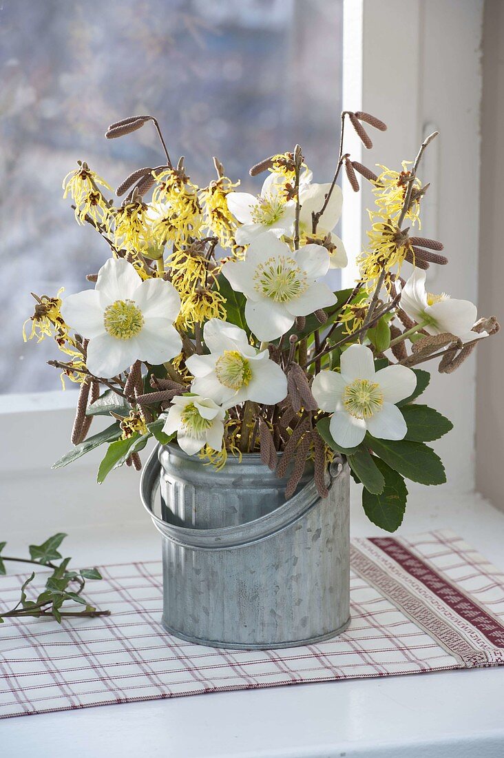 Winter bouquet with Helleborus niger (Christmas roses), twigs