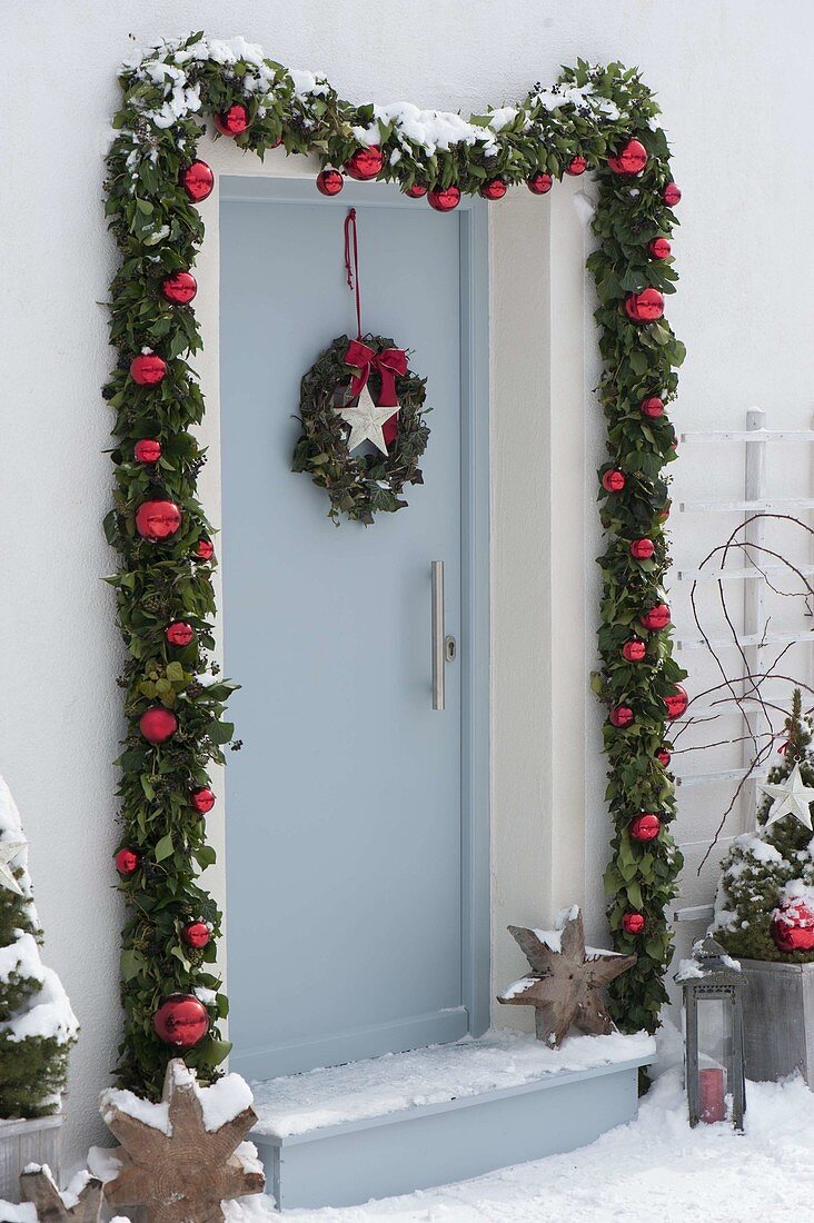 Decorate front door with garland for Christmas