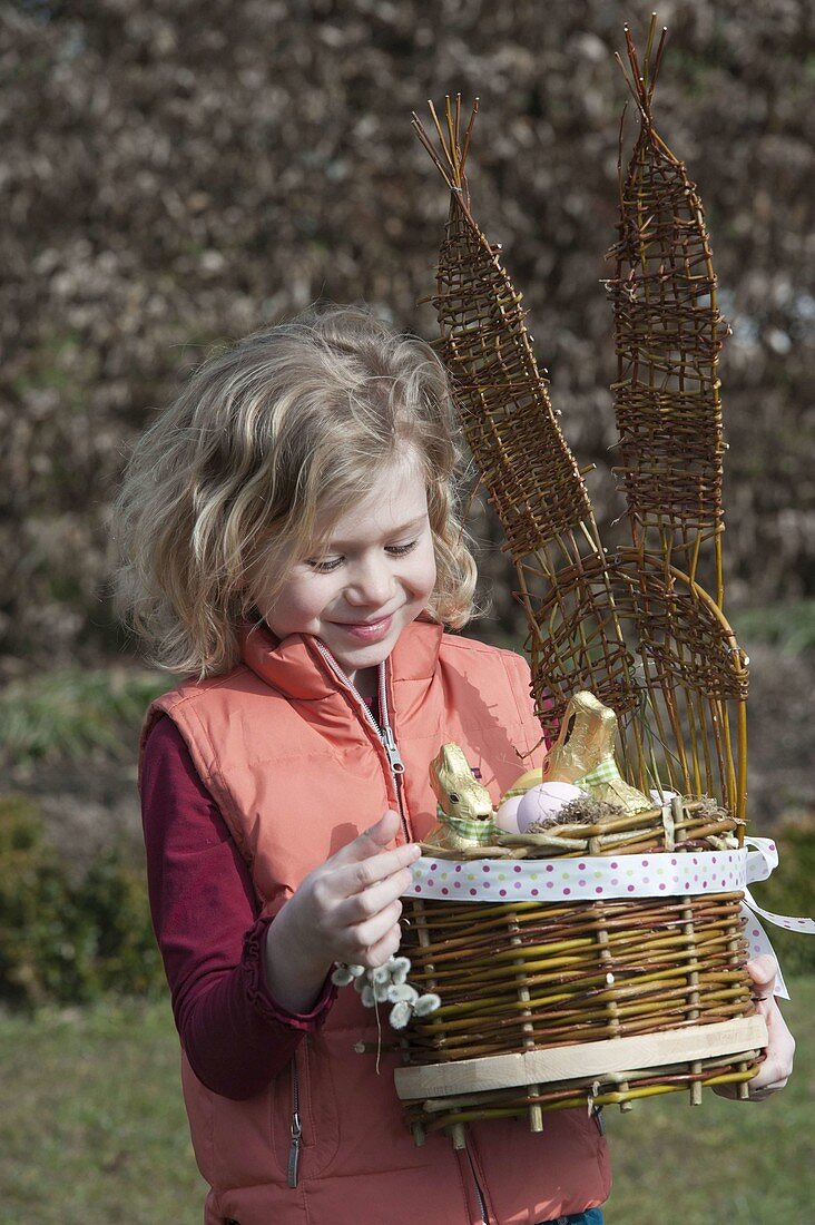 Girl with homemade easter basket with bunny head as easter nest