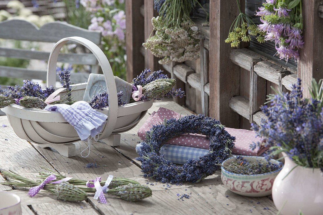 Wreath of lavender (Lavandula) and basket with flowers, lavender bottles
