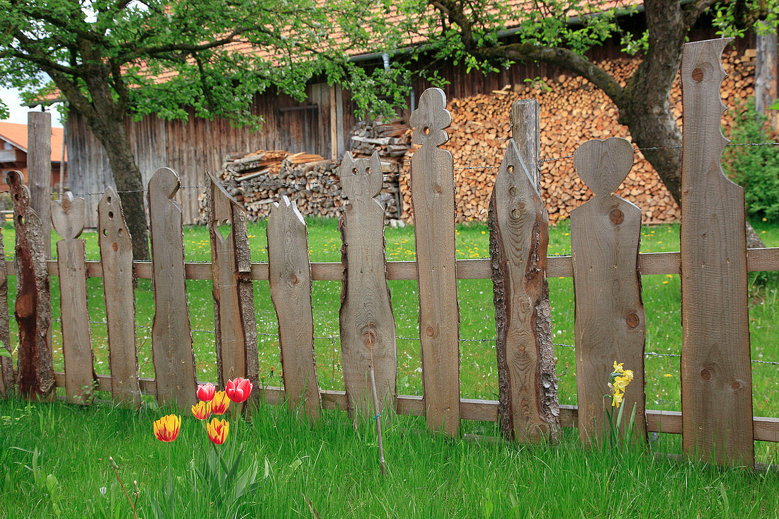 Homemade fence made of artistically designed boards