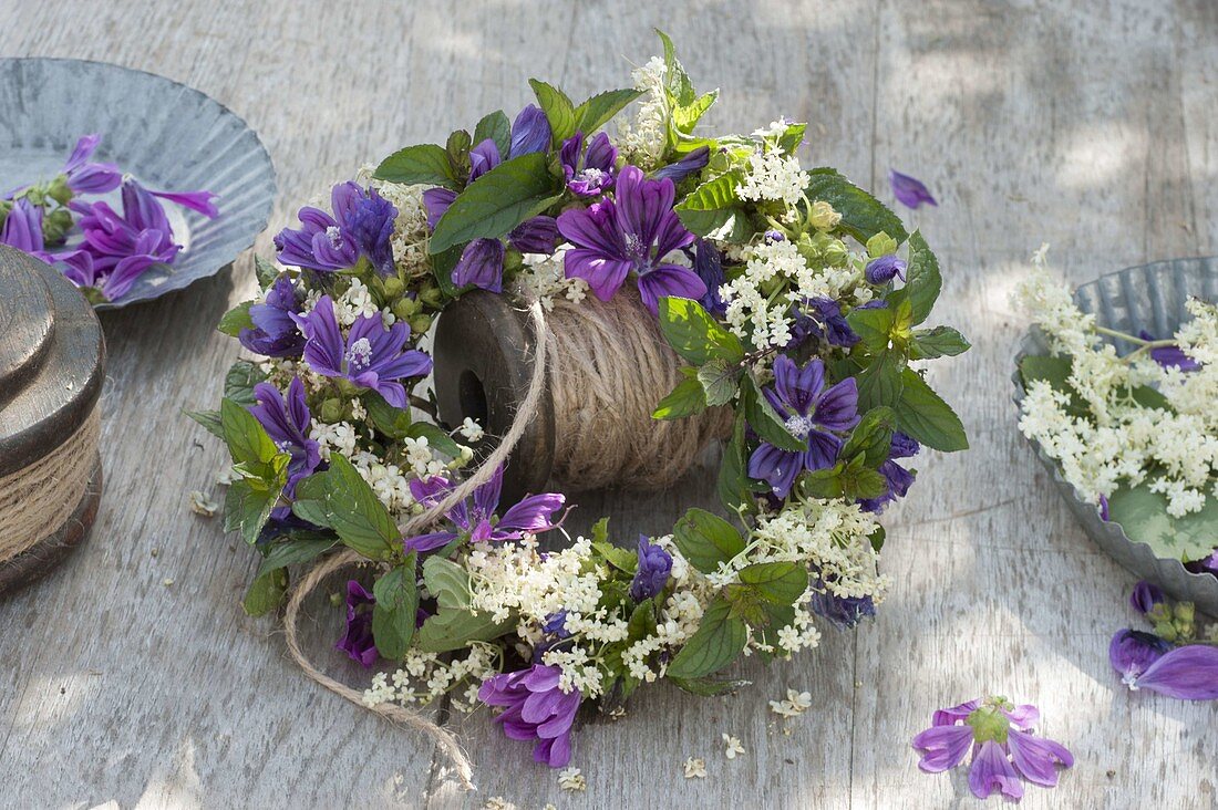 Wreaths with blossoms of Malva sylvestris (mallow), elderberry