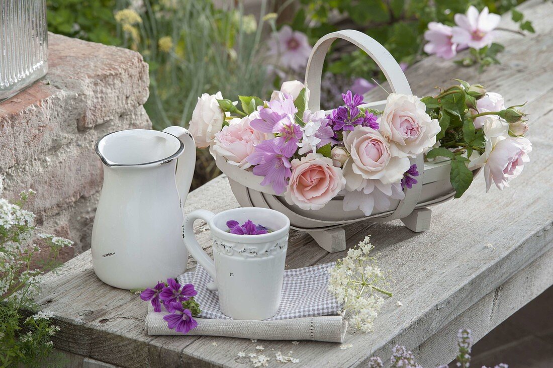 Basket with freshly cut flowers for tea