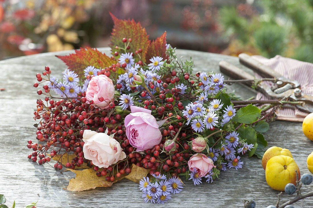 Ingredients for autumn bouquet: pinks (roses and rose hips), aster