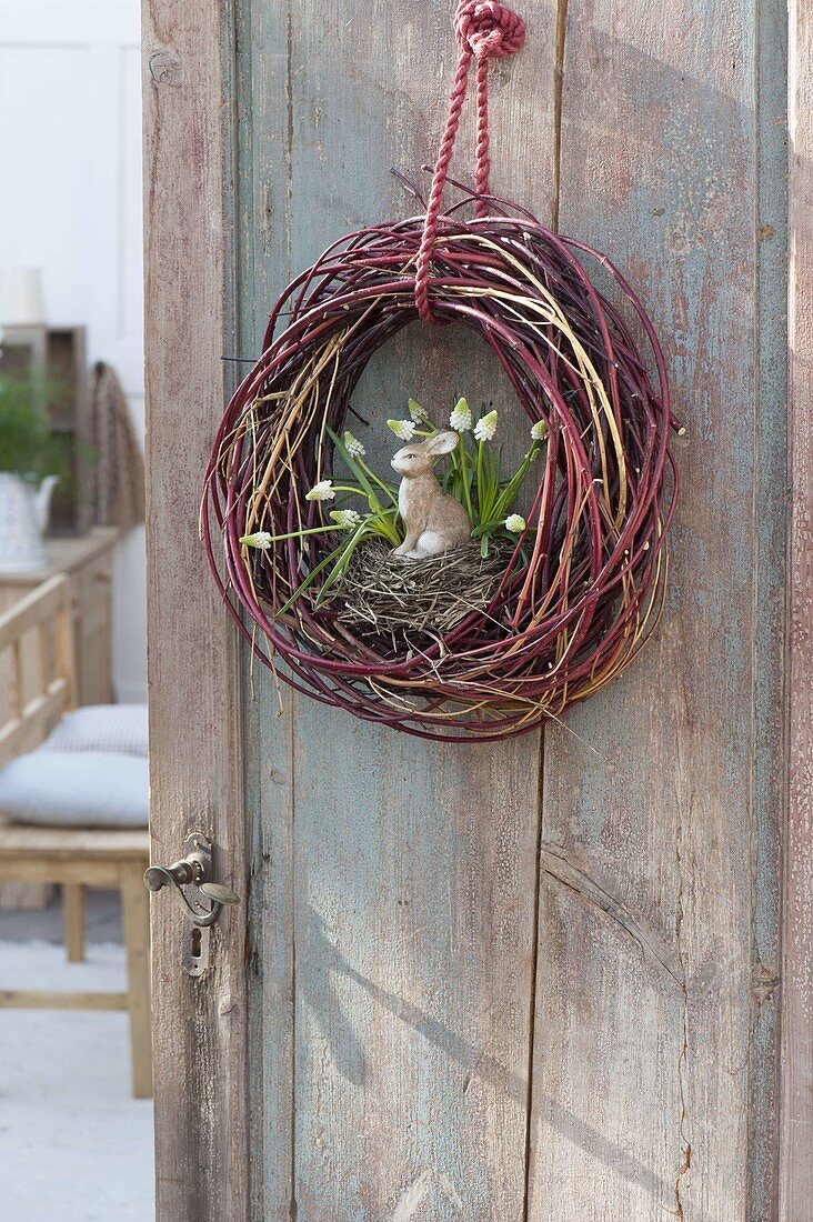 Wreath of different-colored branches of cornus on door