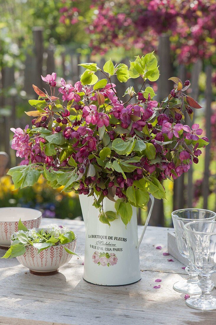 Bouquet of branches of Malus and Tilia in jug