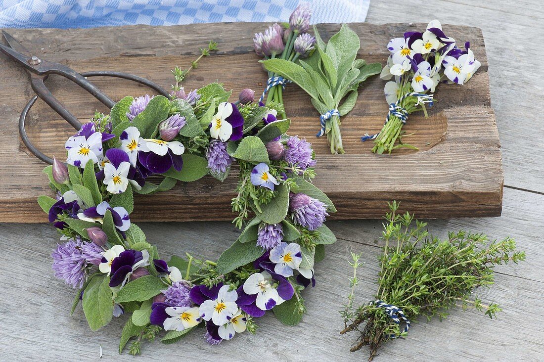 Tying a small wreath of herbs and edible flowers