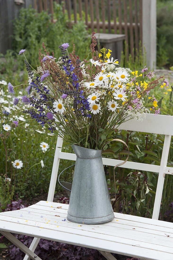 Flower meadow bouquet of Leucanthemum vulgare in zinc can