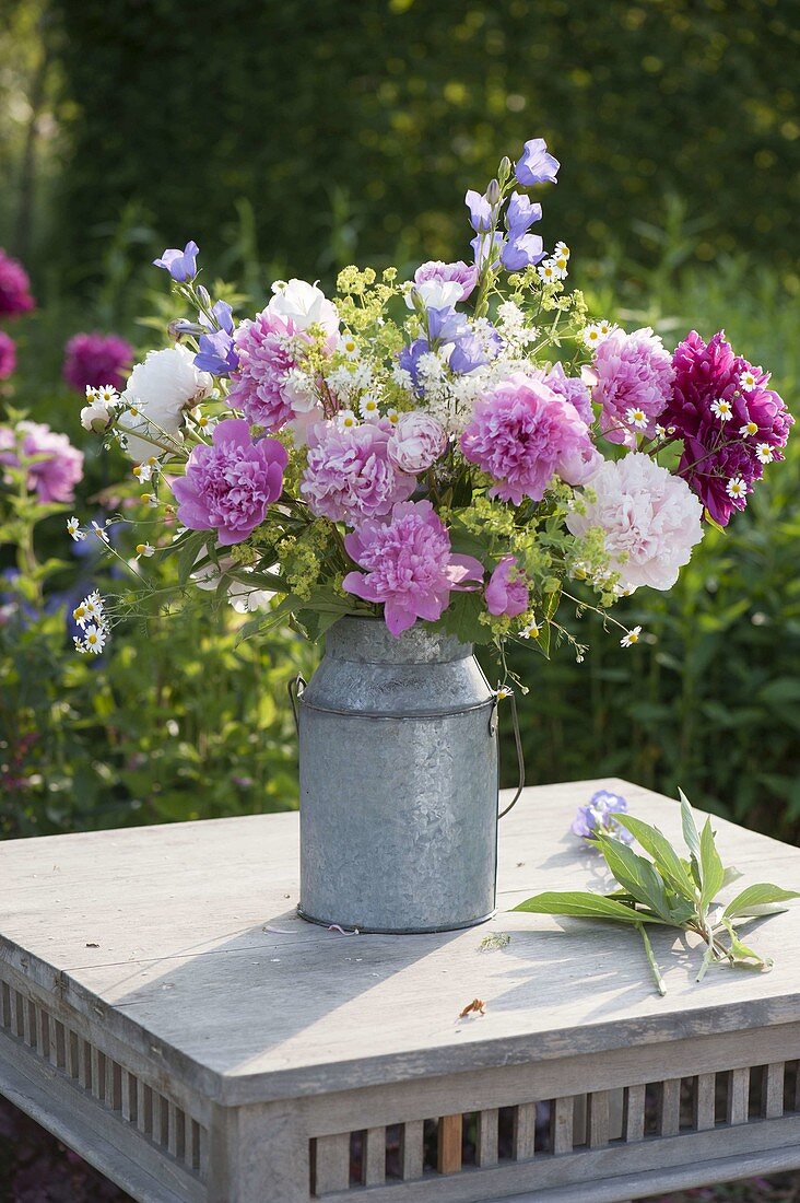 Whitsun bouquet in old zinc milk jug