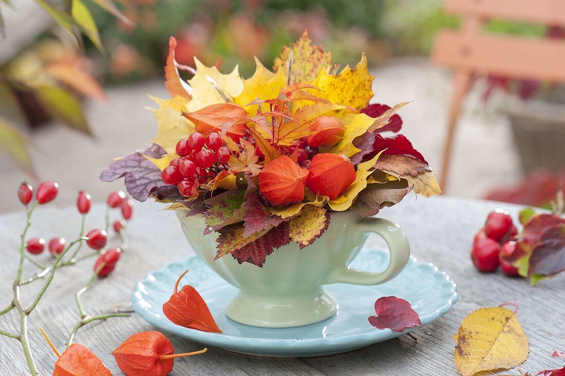 Small autumn bouquet in cup on coaster