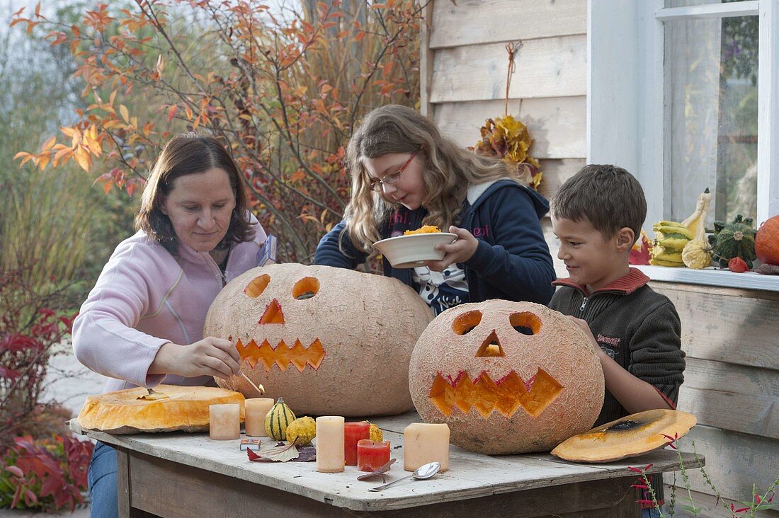 Family carving pumpkins for Halloween