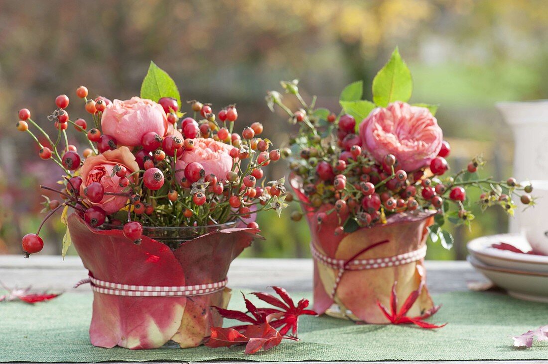 Small bouquets made of roses (rosehip) in glasses
