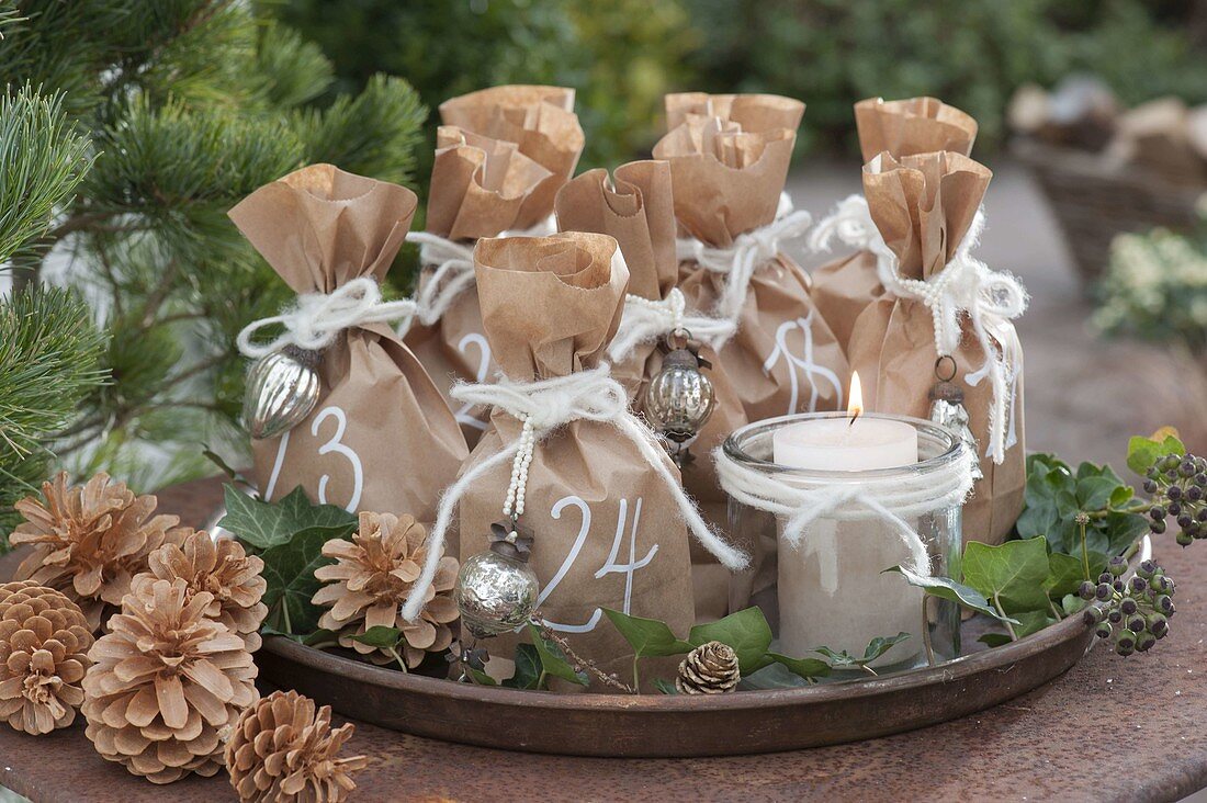 Numbered paper bags as an advent calendar on a round tray